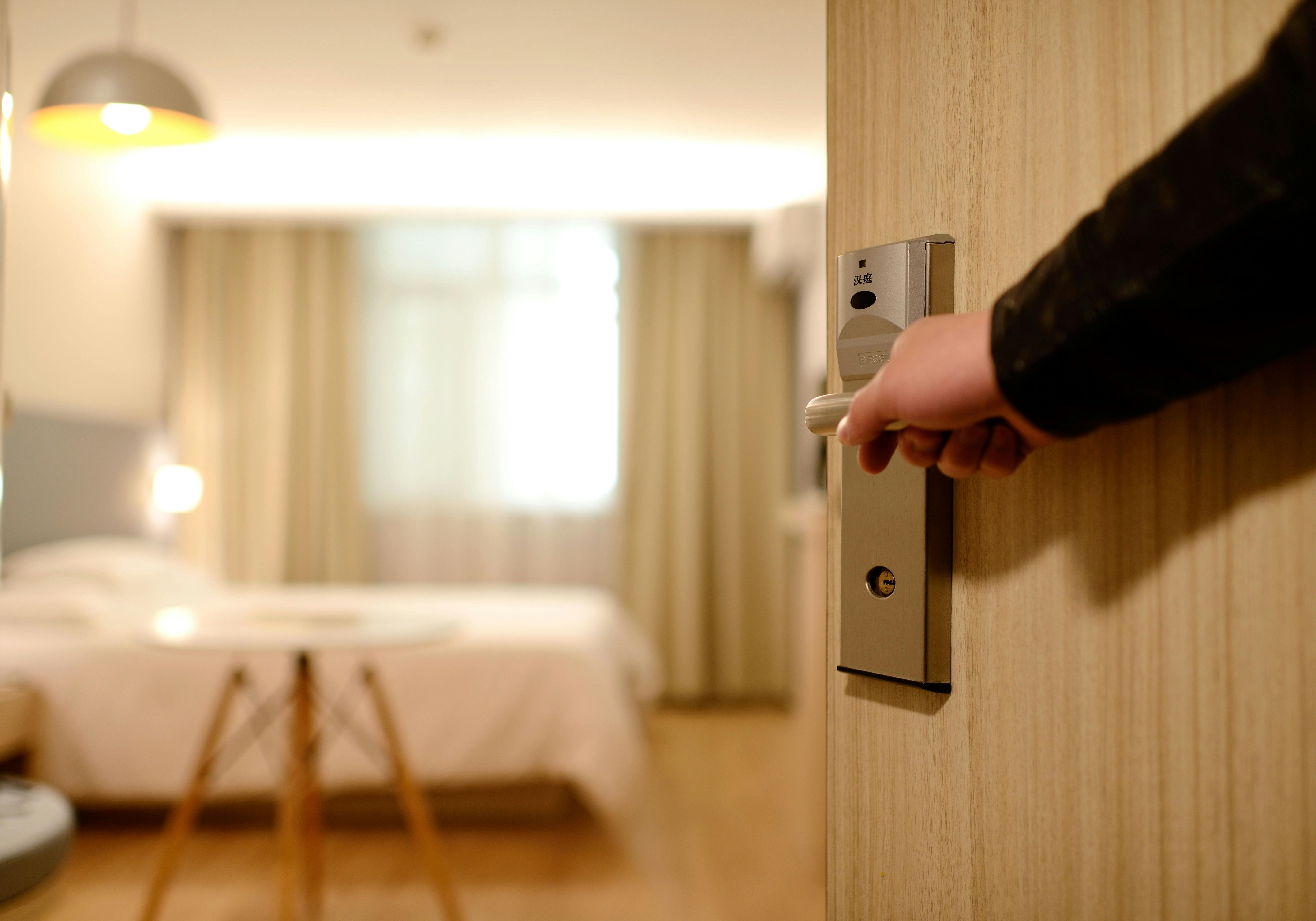 person holding the hotel room door